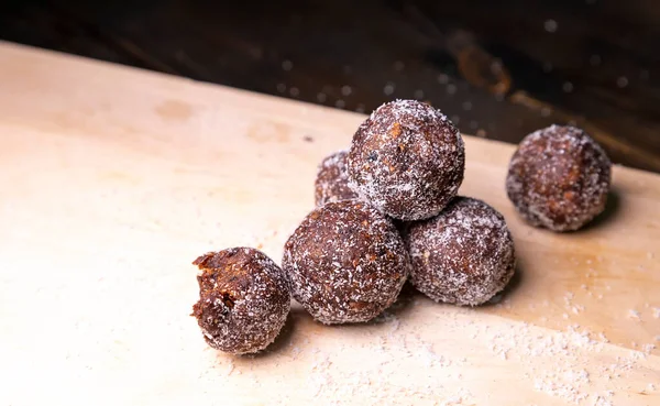 Homemade energy balls with dates, walnuts, almonds and coconut. Healthy sweet food. Copy space Energy balls in a bowl on a white background.Raw energy balls, all natural healthy raw energy bites