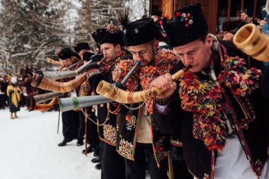 Kryvorivnia, Ukrayna - 7 Ocak 2019: Kryvorivnia 'lı ünlü hutzulian Koliadnyky Noel şarkıları söylüyor ve geleneksel trembita boynuzuyla çalıyor. - Evet. Karpatya 'nın eski kış tatili gelenekleri .