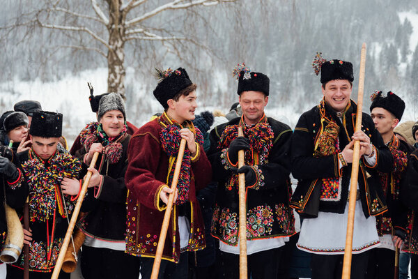 Kryvorivnia, Ukraine - January 7, 2019: Famous hutzulian Koliadnyky of Kryvorivnia singing Christmas carols and playing on traditional trembita horn. . Old winter holiday traditions of Carpathian .