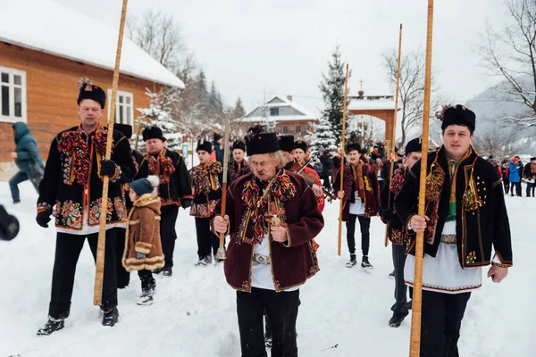 Kryvorivnia, Ucrania - 7 de enero de 2019: Famoso hutzulian Koliadnyky de Kryvorivnia cantando villancicos y tocando en el tradicional cuerno de trembita. .. Viejas tradiciones navideñas de invierno de los Cárpatos moun —  Fotos de Stock