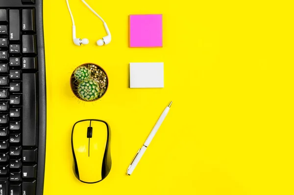 flat lay workspace yellow computer mouse, office accessory on yellow background with copy space