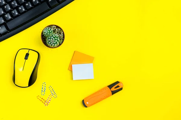 flat lay workspace yellow computer mouse, office accessory on yellow background with copy space