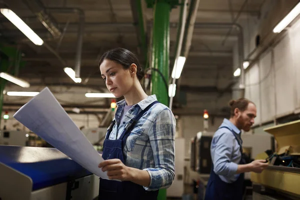 Young Engineer Work Wear Concentrating Examine Blueprint While Colleague Working — Stok fotoğraf