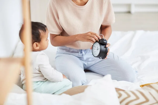 Close Mother Holding Alarm Clock Checking Time Baby Sitting Bed — 图库照片