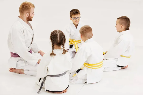 Groep Jonge Judoïsten Kimono Die Vloer Zitten Luisteren Naar Coach — Stockfoto