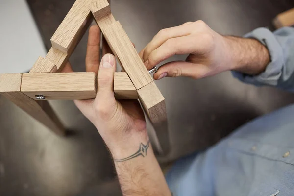 Man making wooden figure