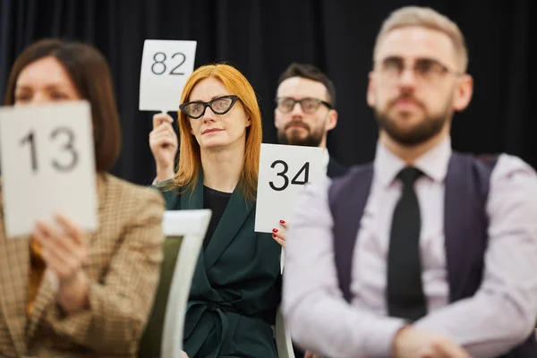 Group of people at auction — Stock Photo, Image