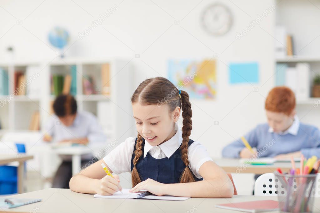 Schoolgirl working at desk