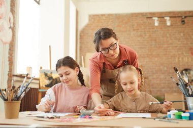 Students with teacher at art lesson