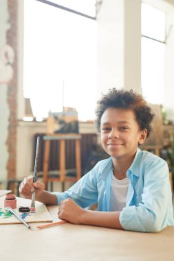 Boy sitting at art lesson