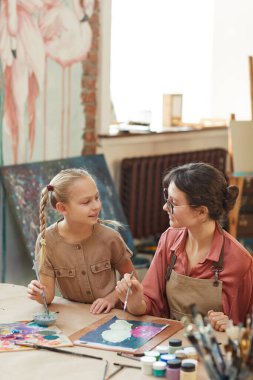 Woman and girl painting