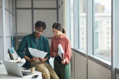 Business partners examining documents