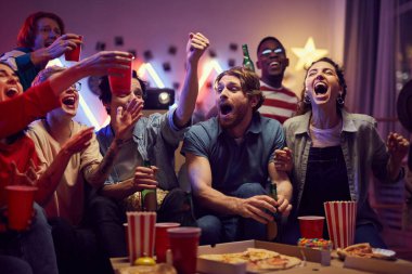 Group of fans having fun at home