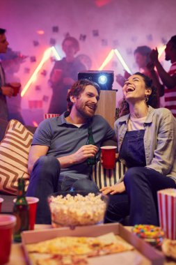 Happy couple sitting at party