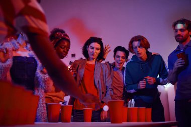 Teenagers playing in beer pong