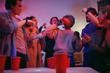 Woman drinking beer at party