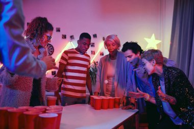 People playing beer pong at party