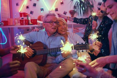 Senior couple celebrating holiday with friends