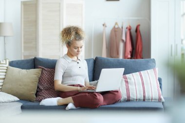 Evde Dizüstü bilgisayar kullanan kadın