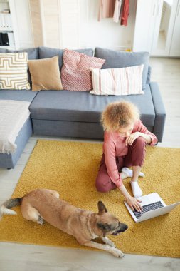 Woman and her dog sitting at home