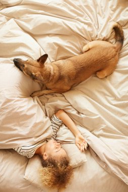 Woman sleeping with her dog