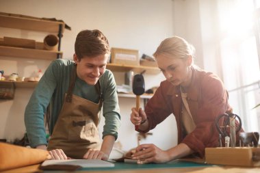 Two Modern Artisans In Workshop