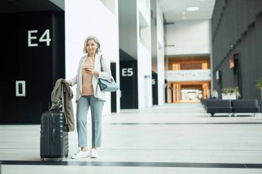 Senior Woman Waiting For Boarding