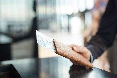 Hand Holding Passport And Flight Ticket