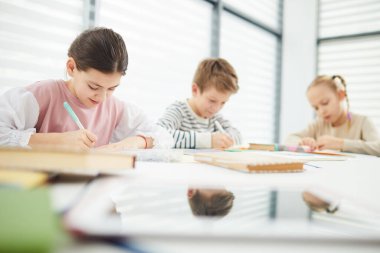 Middle Schoolers Doing Writing Exercise