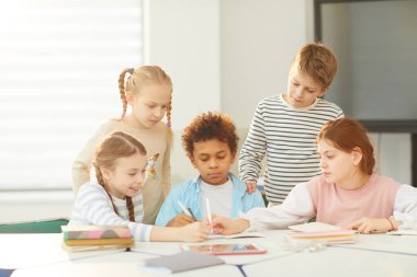 Children Drawing Something In Notebook