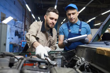 Caucasian Men Working In Auto Service