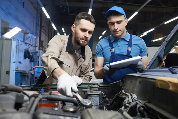 Hommes caucasiens travaillant dans le service automobile — Photo
