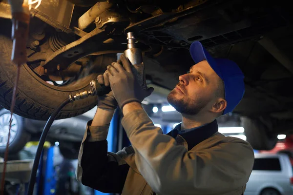 Repairman Working Under Car — Stok fotoğraf