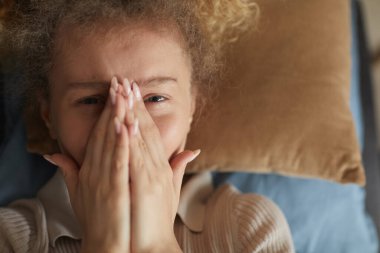 Sad woman lying on sofa