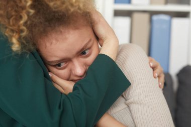 Sad woman embracing with her friend