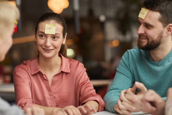 Young couple playing the game with friends — Stock Photo, Image