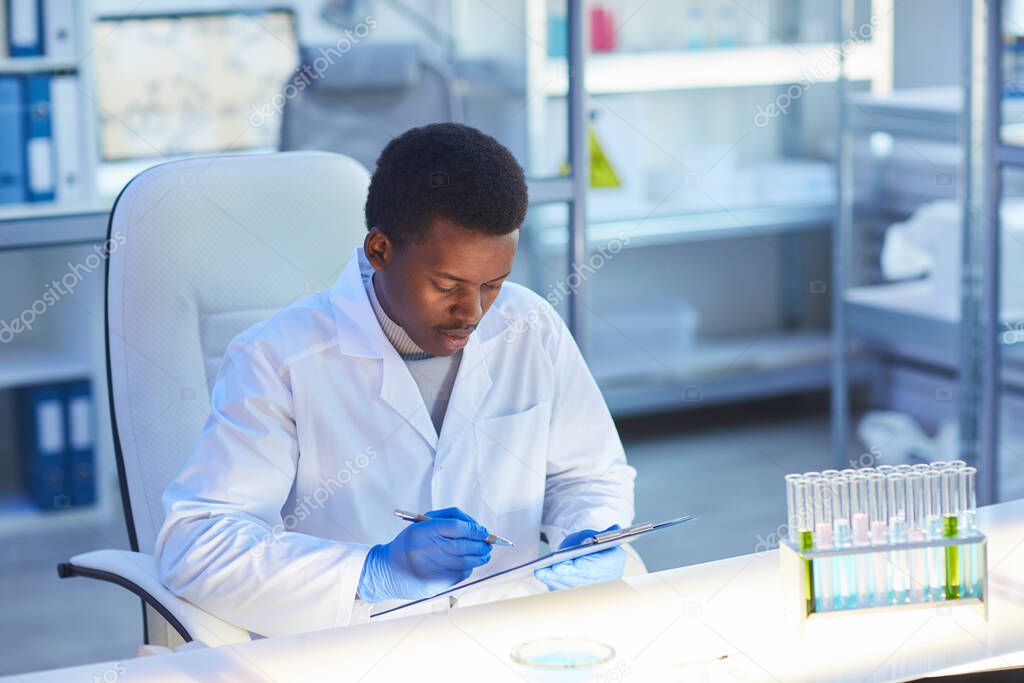 African scientist working at his workplace
