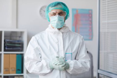 Koruyucu iş kıyafeti giyen erkek doktor.