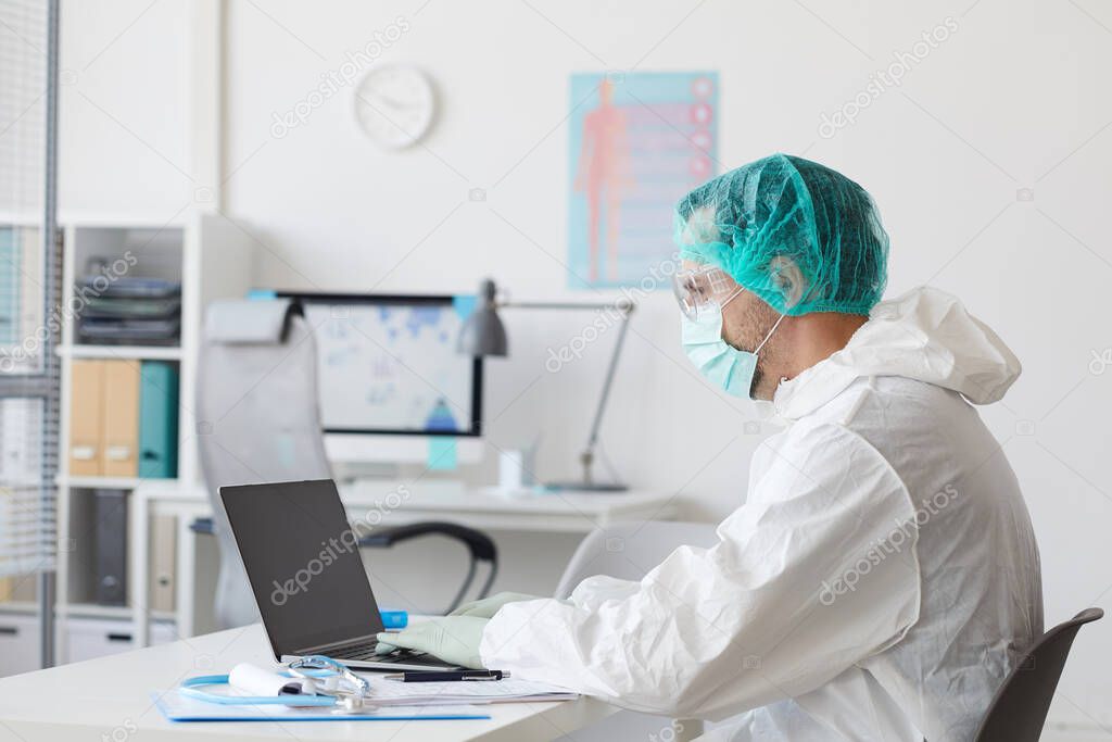 Doctor using laptop at work