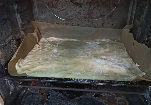 tray with dough in oven