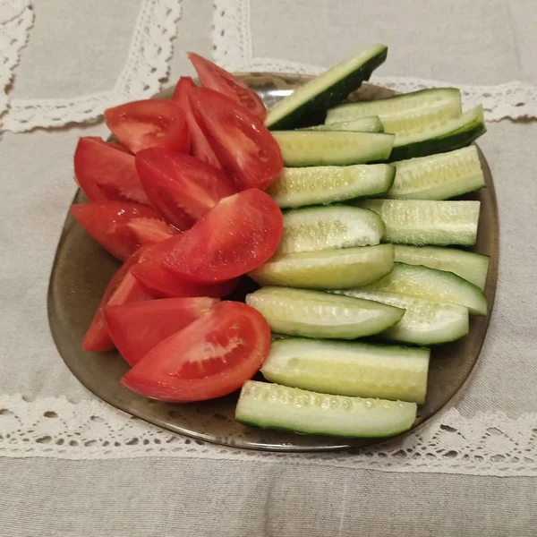 Tomaten und Gurken in Scheiben geschnitten auf Teller — Stockfoto