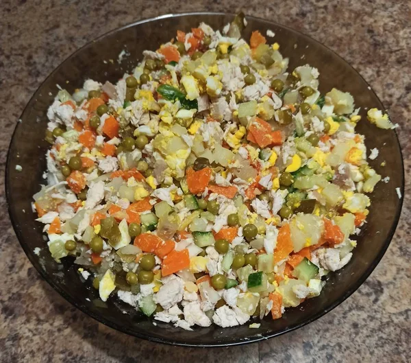 Bowl with Russian salad on kitchen table — Stock Photo, Image