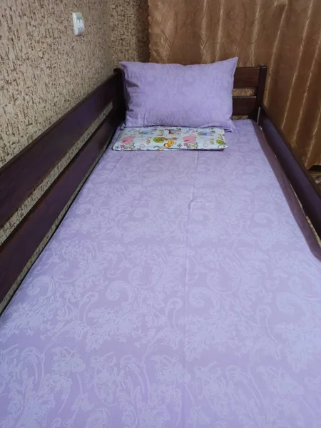 Make-up wooden baby bed with pillows in bedroom — стоковое фото