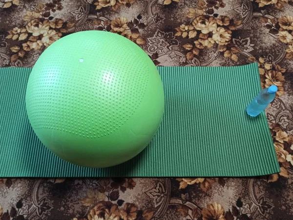 Fitness ball, fitness mat and bottle with water