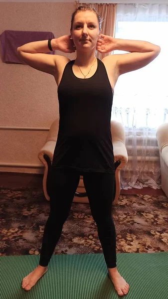European woman practicing yoga at home
