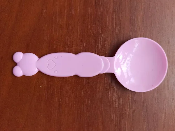 Toy spoon on wooden background — 图库照片