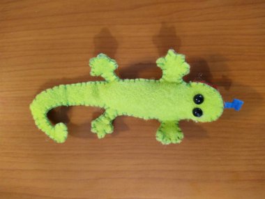 Lizard toy on wooden background
