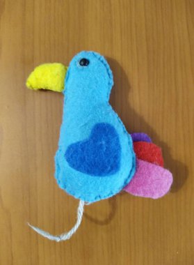 Parrot toy on wooden background