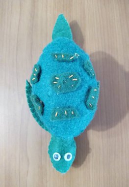 Turtle toy on wooden background