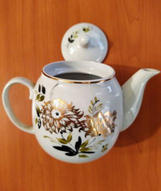 Kettle on table wooden background